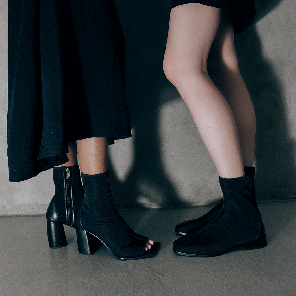 Two models one wearing Aliza boots, one, styled with skirts for a side-by-side contrast.
