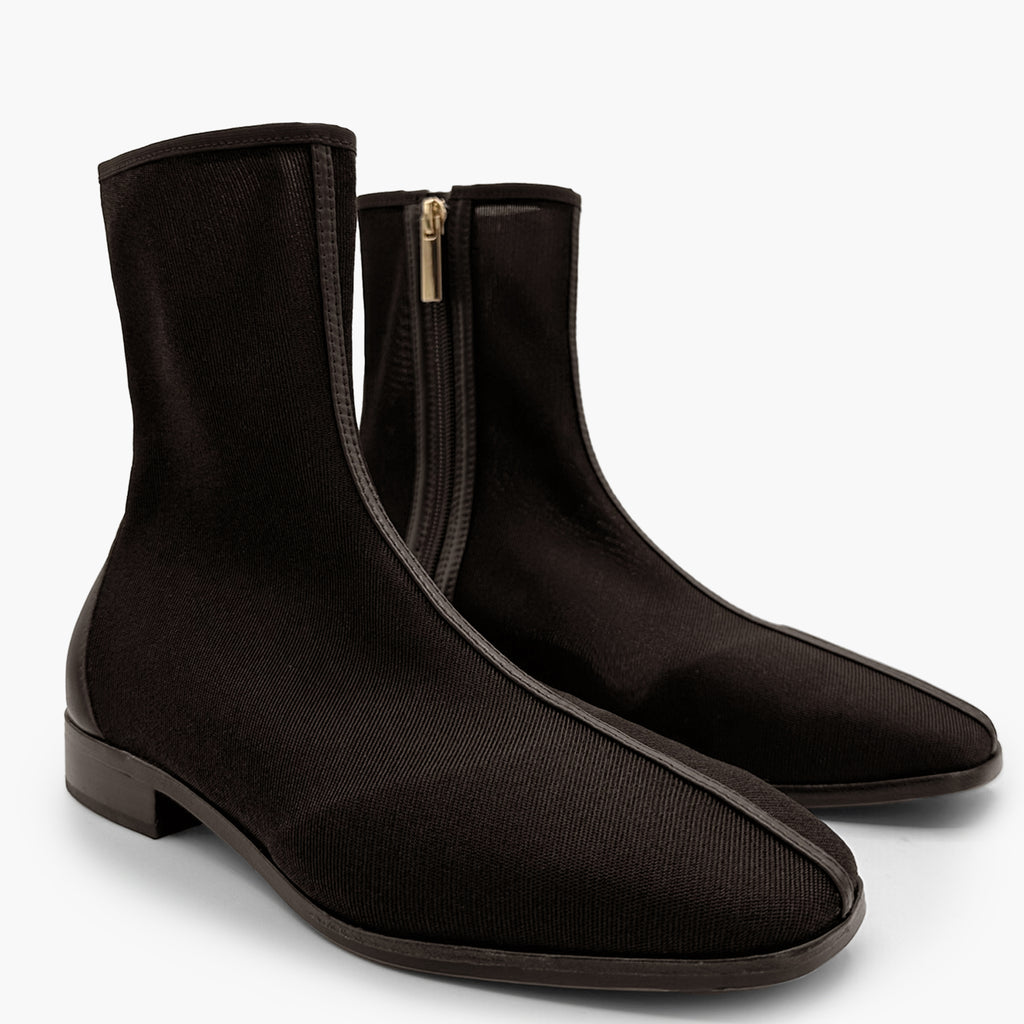 Pair of Daniella Shevel Aliza Mesh Booties in brown, angled to highlight fine stitching and side zipper detail.