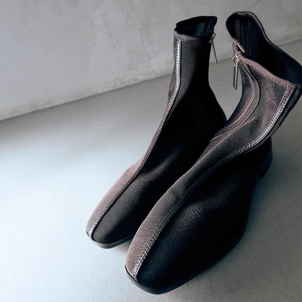 Studio detail shot of Aliza Brown boots placed side by side, highlighting artisanal mesh construction.