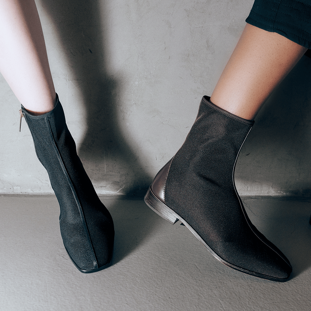 Side angle of Daniella Shevel Aliza Brown boots in motion, highlighting comfort and flexible fit.