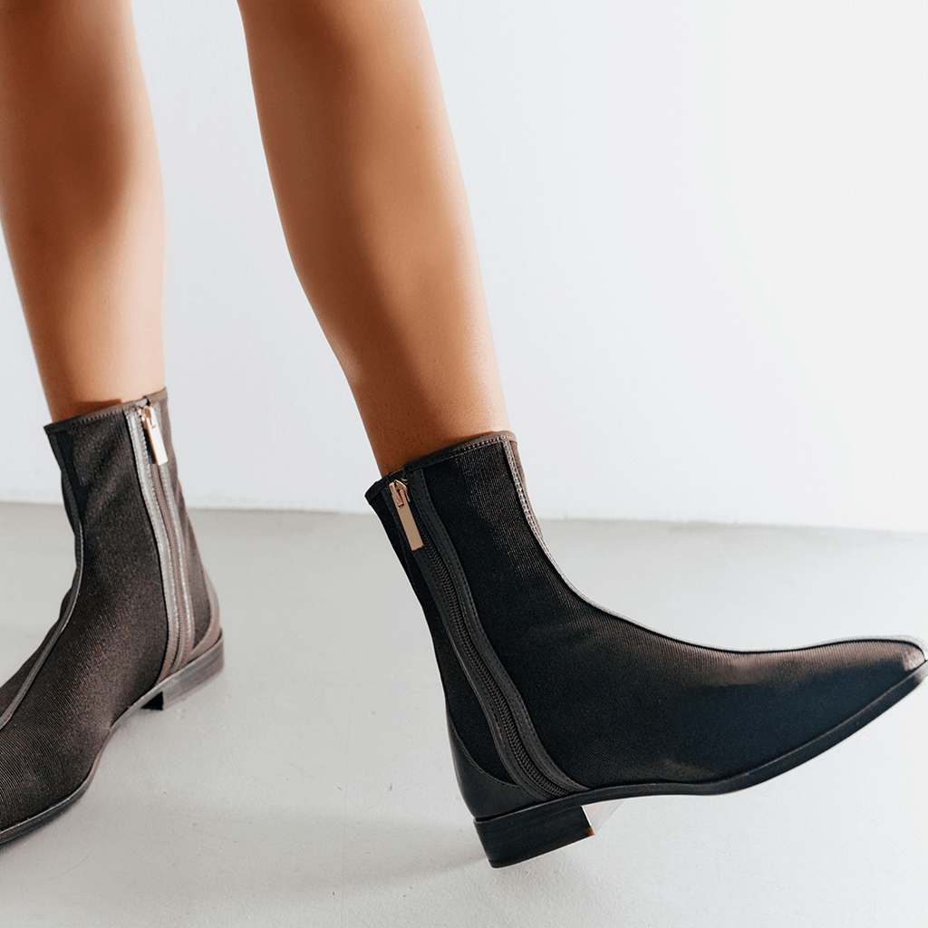 Side profile of model wearing Aliza Brown boots, capturing sleek ankle fit and timeless silhouette.