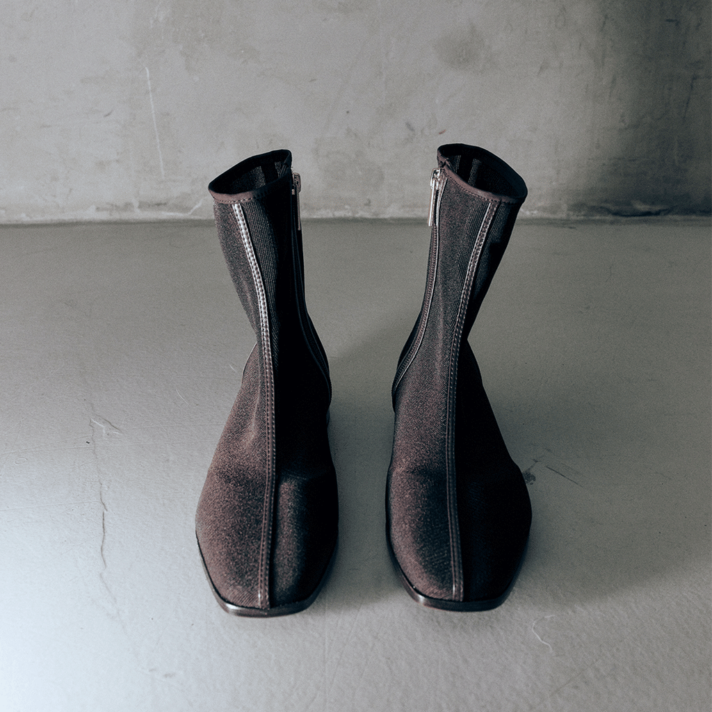 Studio back view of Aliza Brown boots side by side, showcasing sleek lines and zipper design.