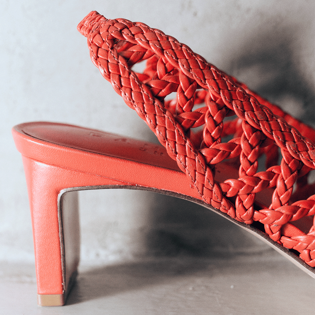 Close-up of the red Cora slingback heel highlighting the handwoven leather and sleek tapered heel design.


