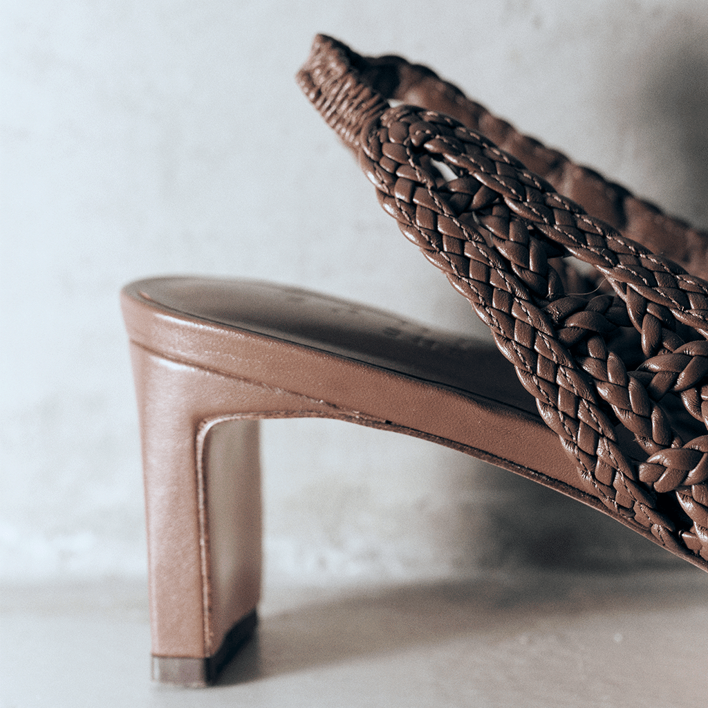 Detail shot of the Cora brown slingback heel by Daniella Shevel, highlighting the intricate handwoven leather and block heel design.

