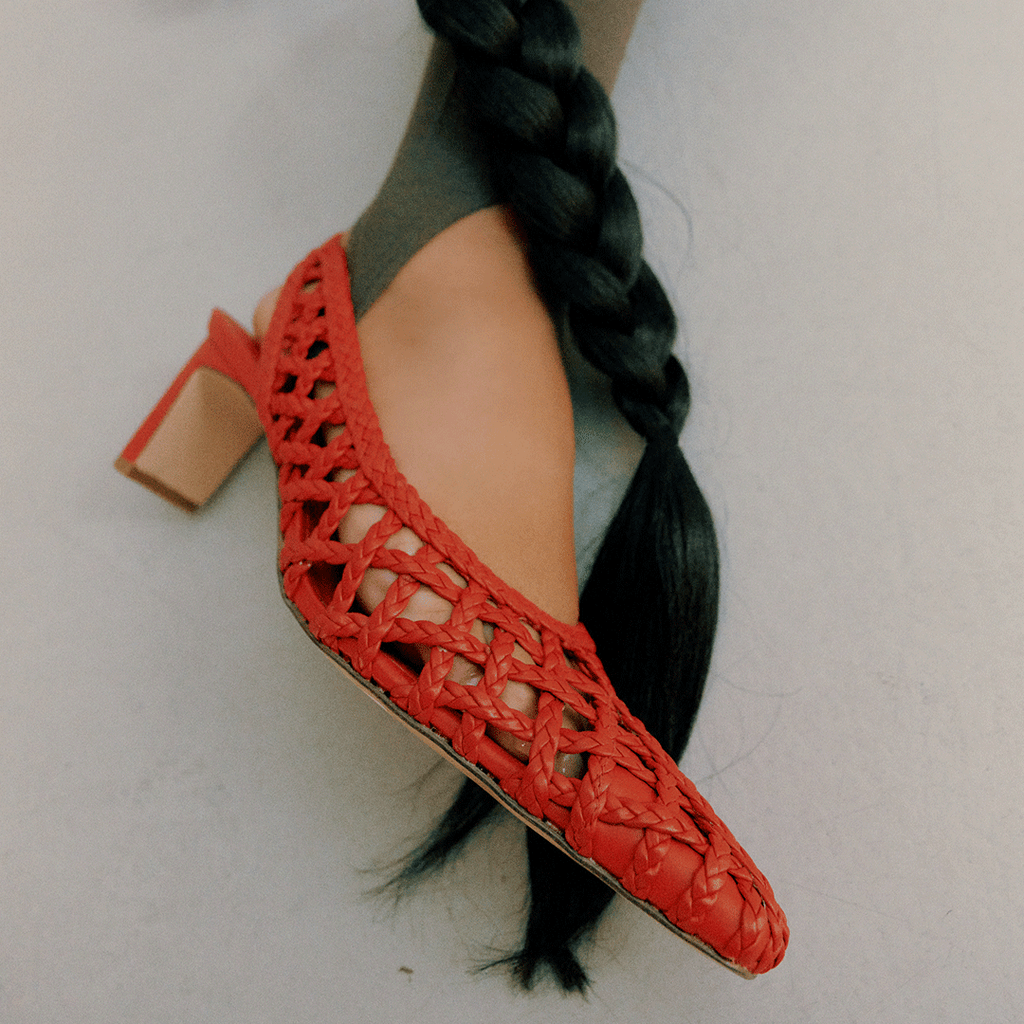 Close-up of the Cora red braided leather slingback heel, featuring the side profile with braided details and slingback strap.

