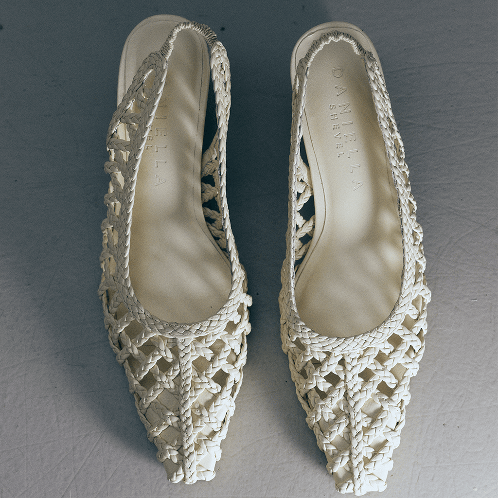 Top-down view of Daniella Shevel's Cora slingback heels in Stone Meringue, showcasing the handwoven leather detail and elegant pointed toe design.

