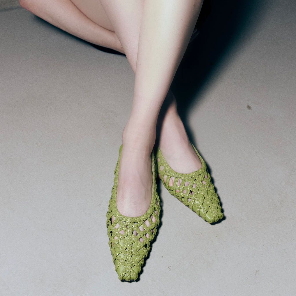 Candid styling shot of model in Wild Moss Halo flats – flattering foot coverage and signature braided texture on display.