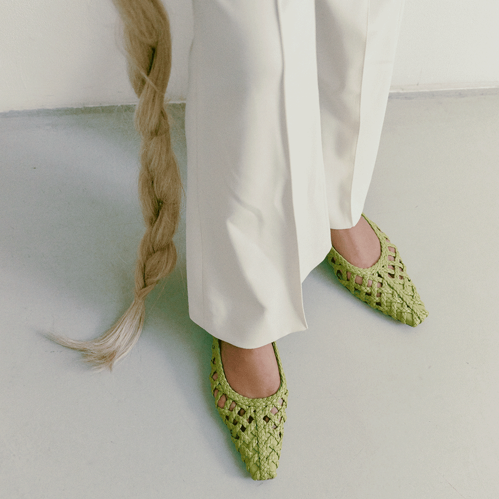 Full outfit shot featuring Wild Moss Halo flats – paired with light pants, the green flats pop with texture and ease.