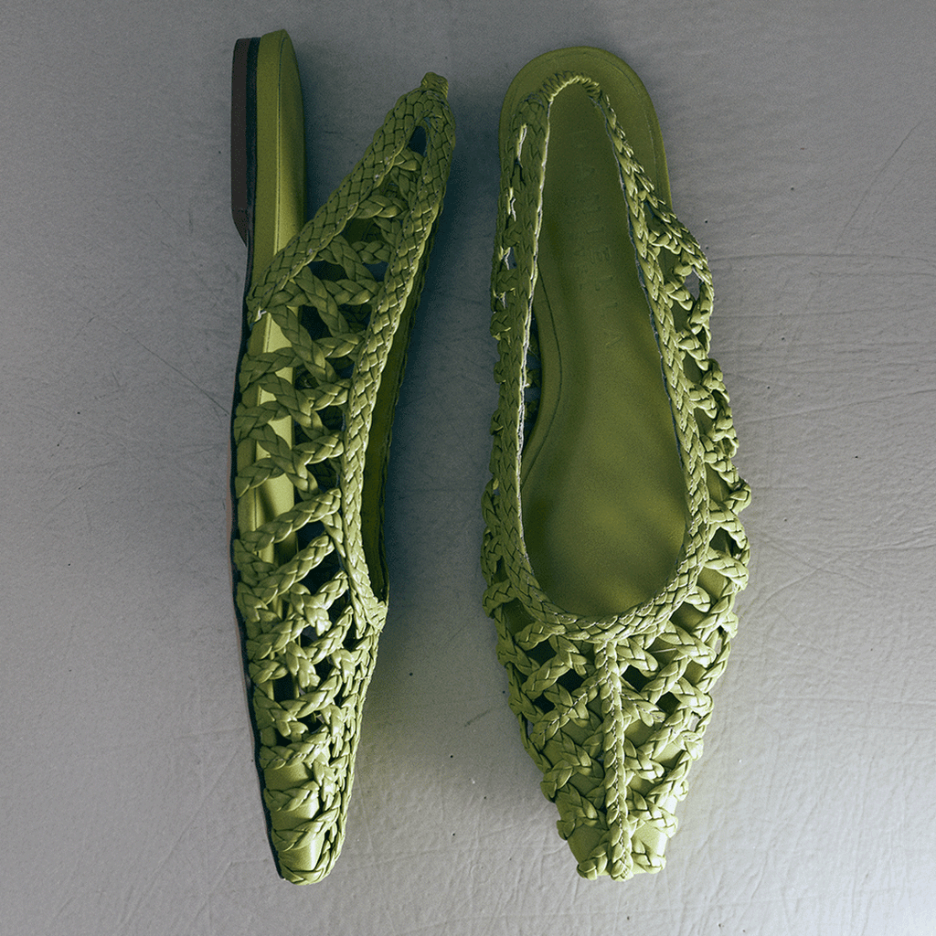 Flat lay of Daniella Shevel Halo flats in Wild Moss – studio-style pair shot emphasizing pointed toe and woven leather details.