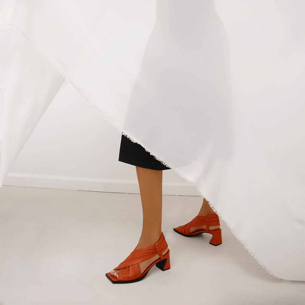 Daniella Shevel Harper lobster red wrap leather sandal with square toe styled in long shorts