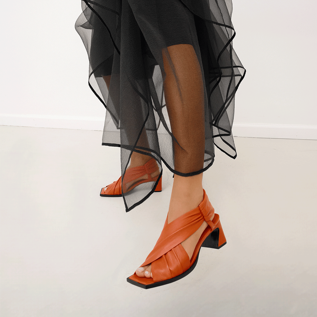 Daniella Shevel Harper lobster red wrap leather sandal with square toe styled in midi skirt