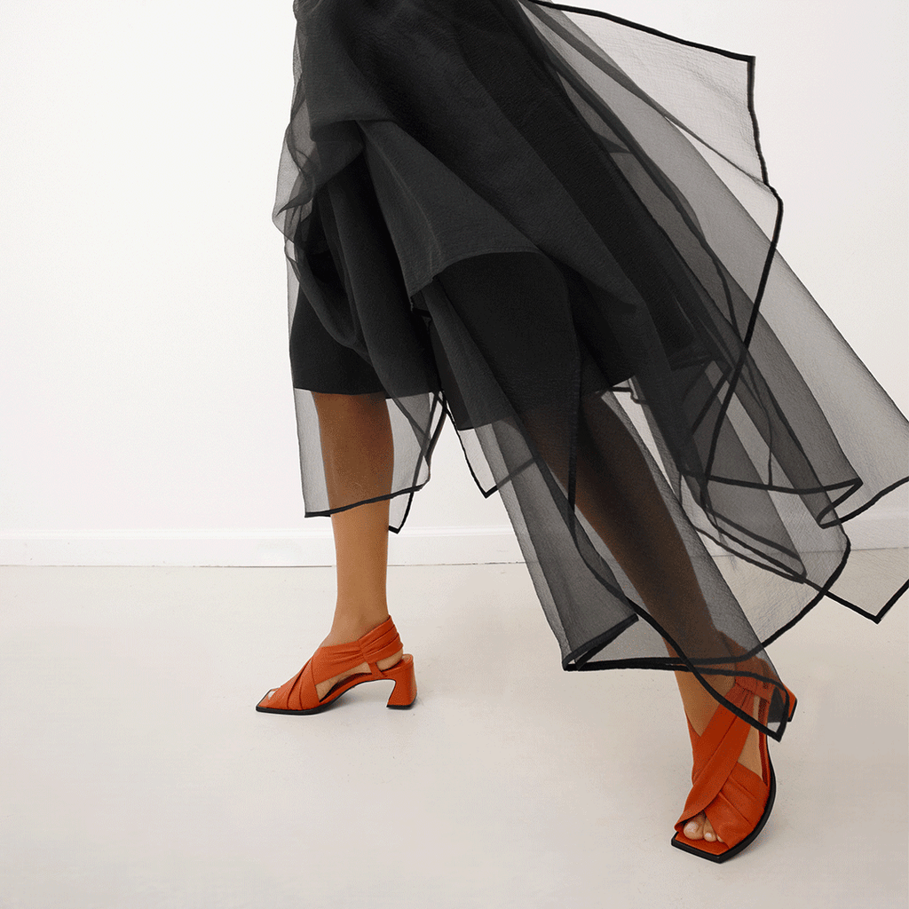 Daniella Shevel Harper lobster red wrap leather sandal with square toe styled in skirt