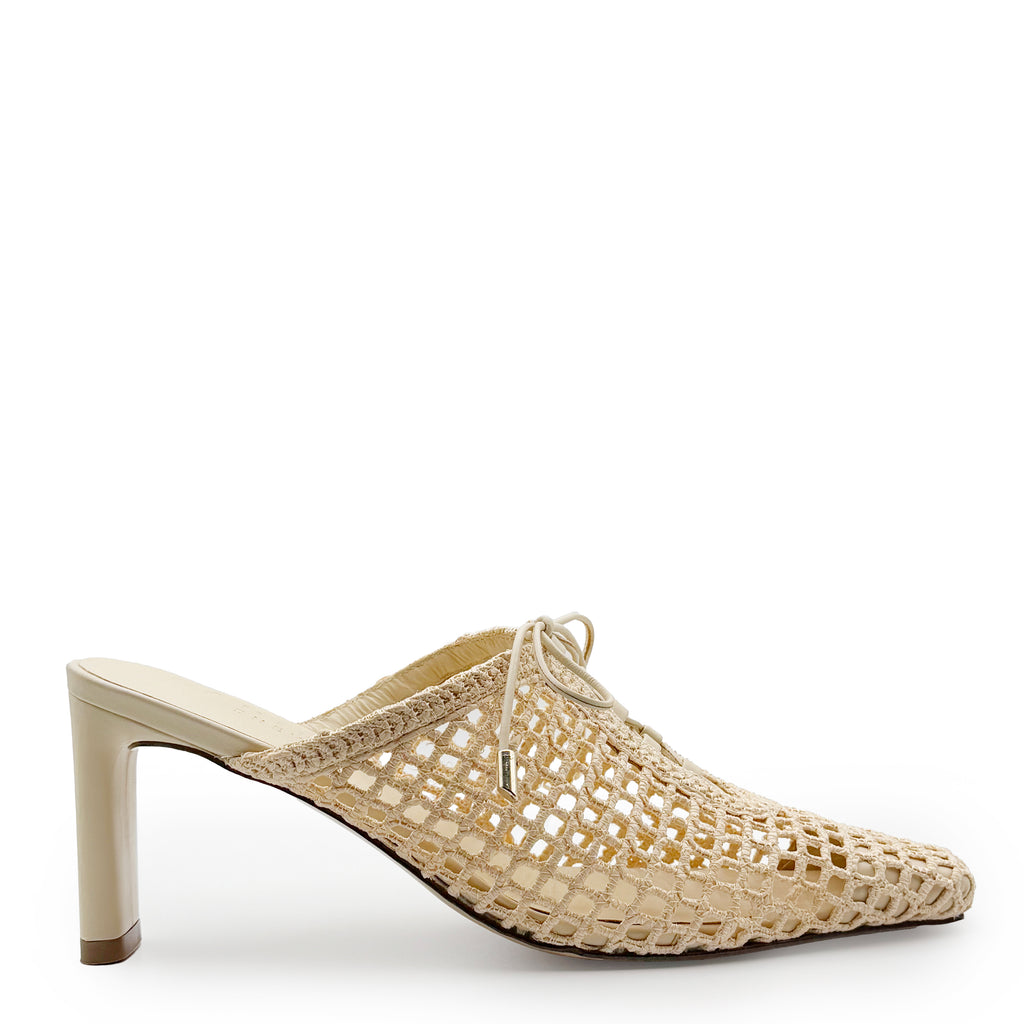Studio side view of Daniella Shevel Bruna Heel Mule in Wild Straw – featuring sleek pointed toe, open-back silhouette, and sculptural stiletto heel.