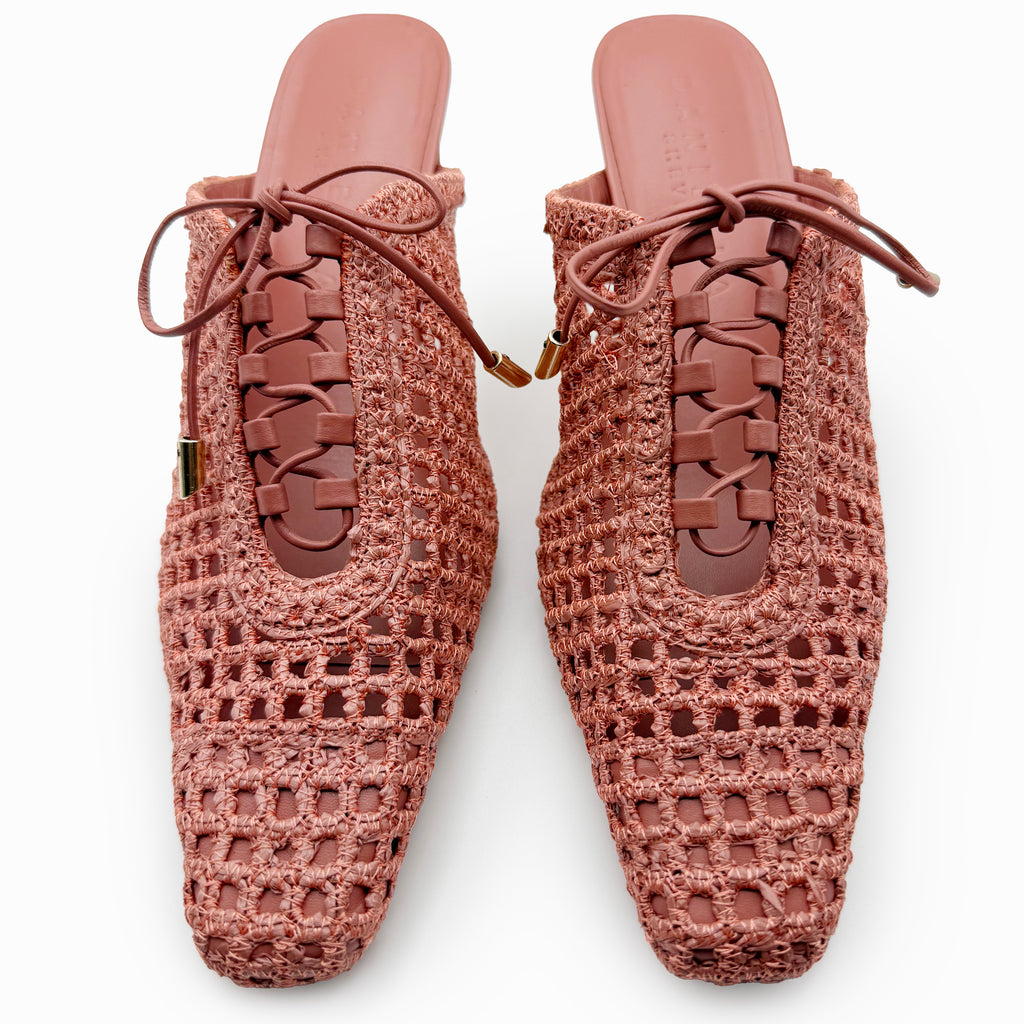 Studio top view of Daniella Shevel Bruna lace-up raffia heel mules in Berry Petal, showcasing the structured square toe, intricate woven texture, and symmetrical lace-up detail.