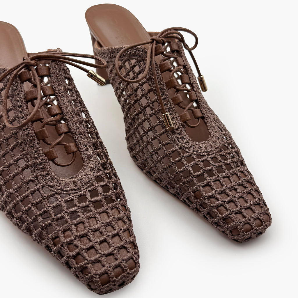 Slightly angled overhead view of Daniella Shevel Bruna lace-up heel mules in Chestnut, capturing the dimensional woven texture and elegant pointed toe construction.