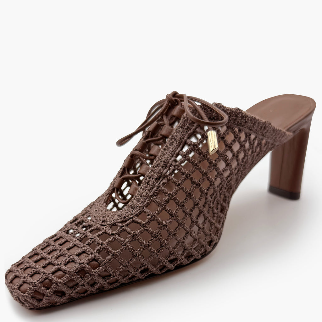 Angled studio shot of Daniella Shevel Bruna raffia heel in Chestnut, showcasing the open weave pattern, sleek silhouette, and tonal leather lacing.