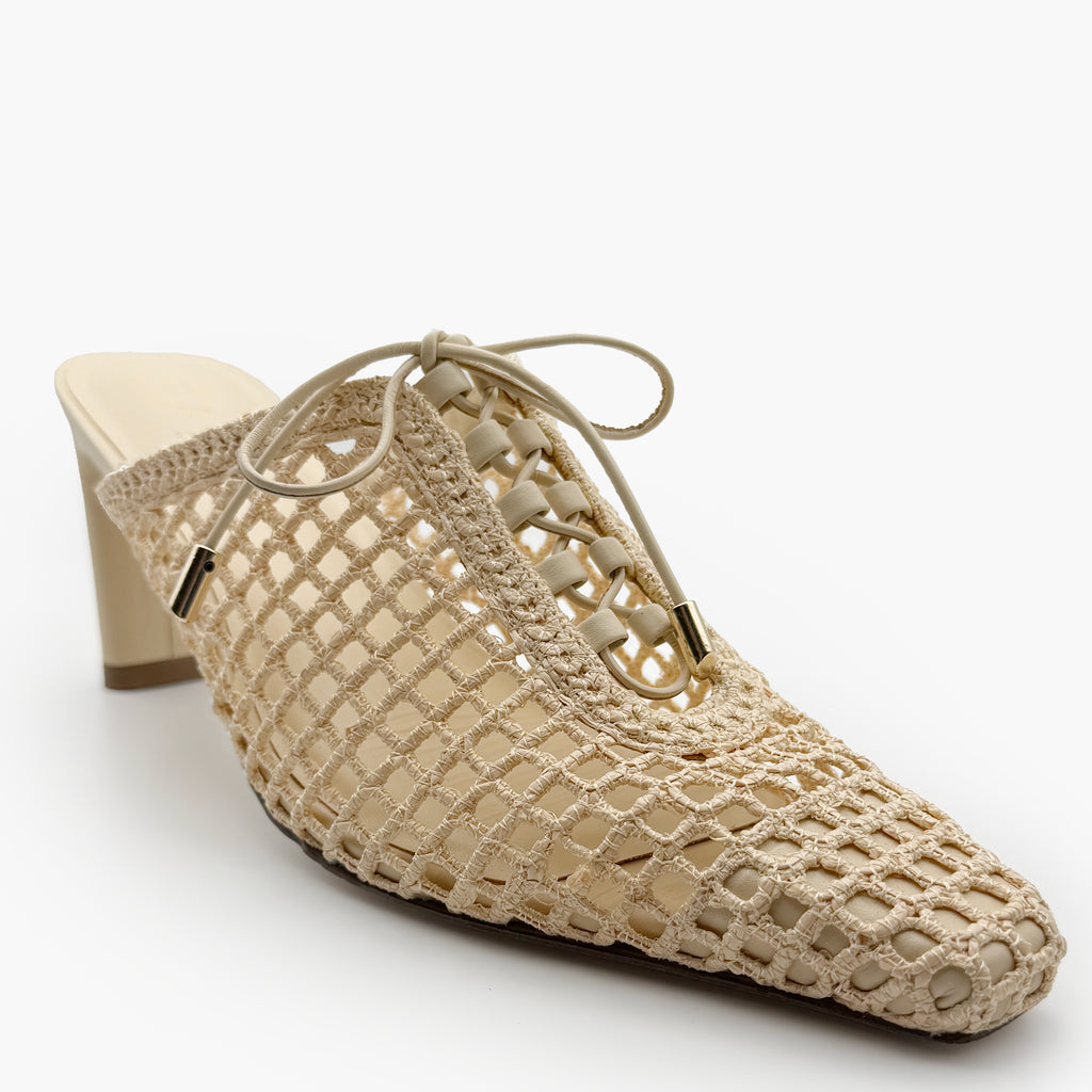 Studio close-up of Daniella Shevel Bruna Heel Mule in Wild Straw – detailed front view of intricate lace-up closure and artisanal raffia weave.