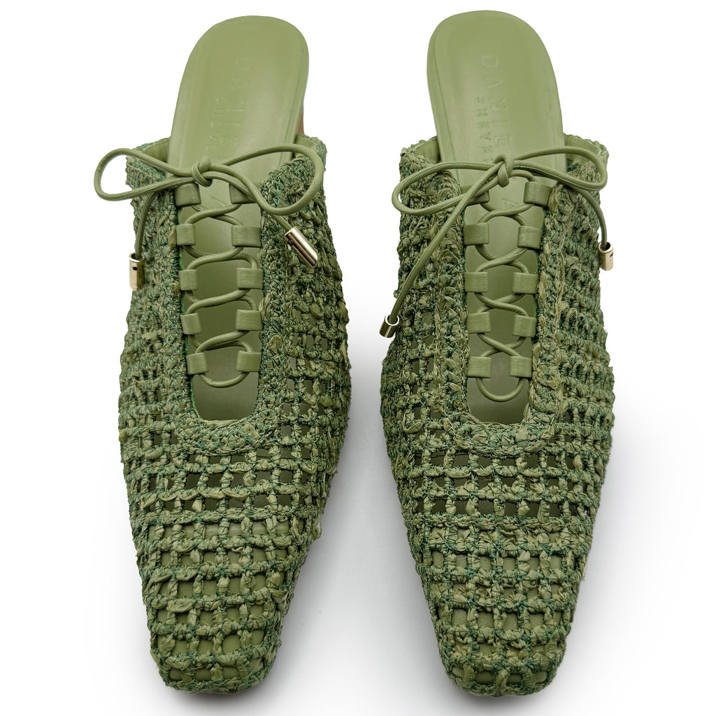 Top-down studio image of Daniella Shevel Lina Mules in Green Moss – symmetrical lace-up closure, almond toe, and rich woven texture.