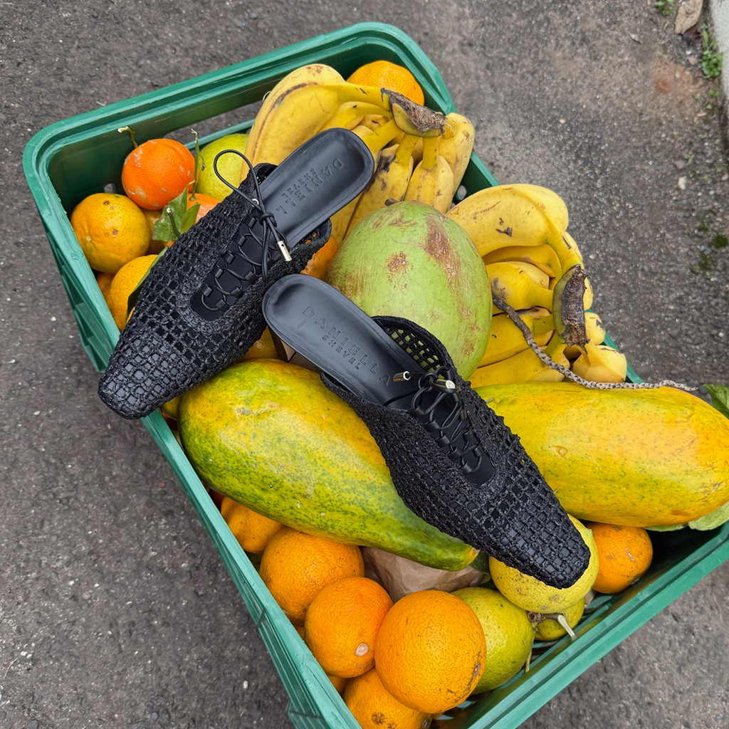  Daniella Shevel Lina mule in black styled playfully and creating a contrast between refined design and organic textures.