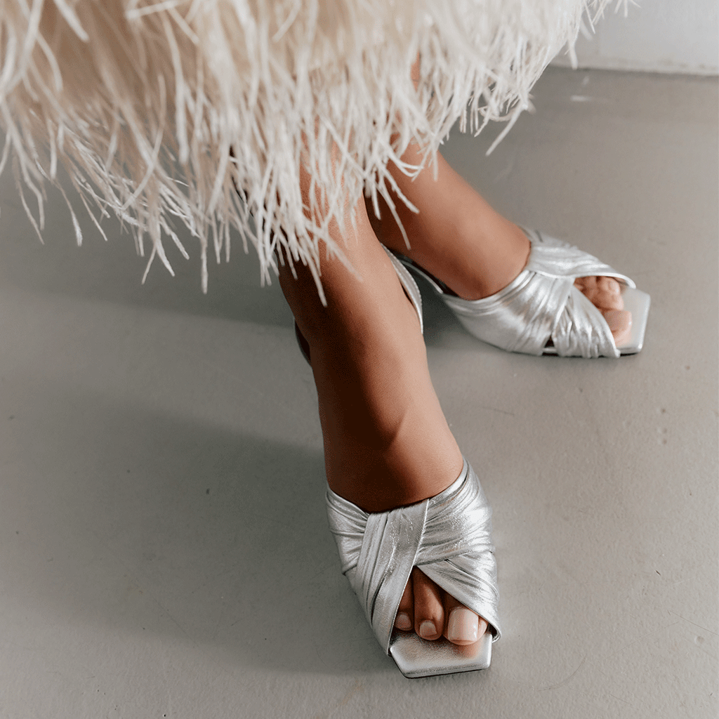 Close-up of Riley Leather Low-Heel in metallic silver, styled with textured detail.
