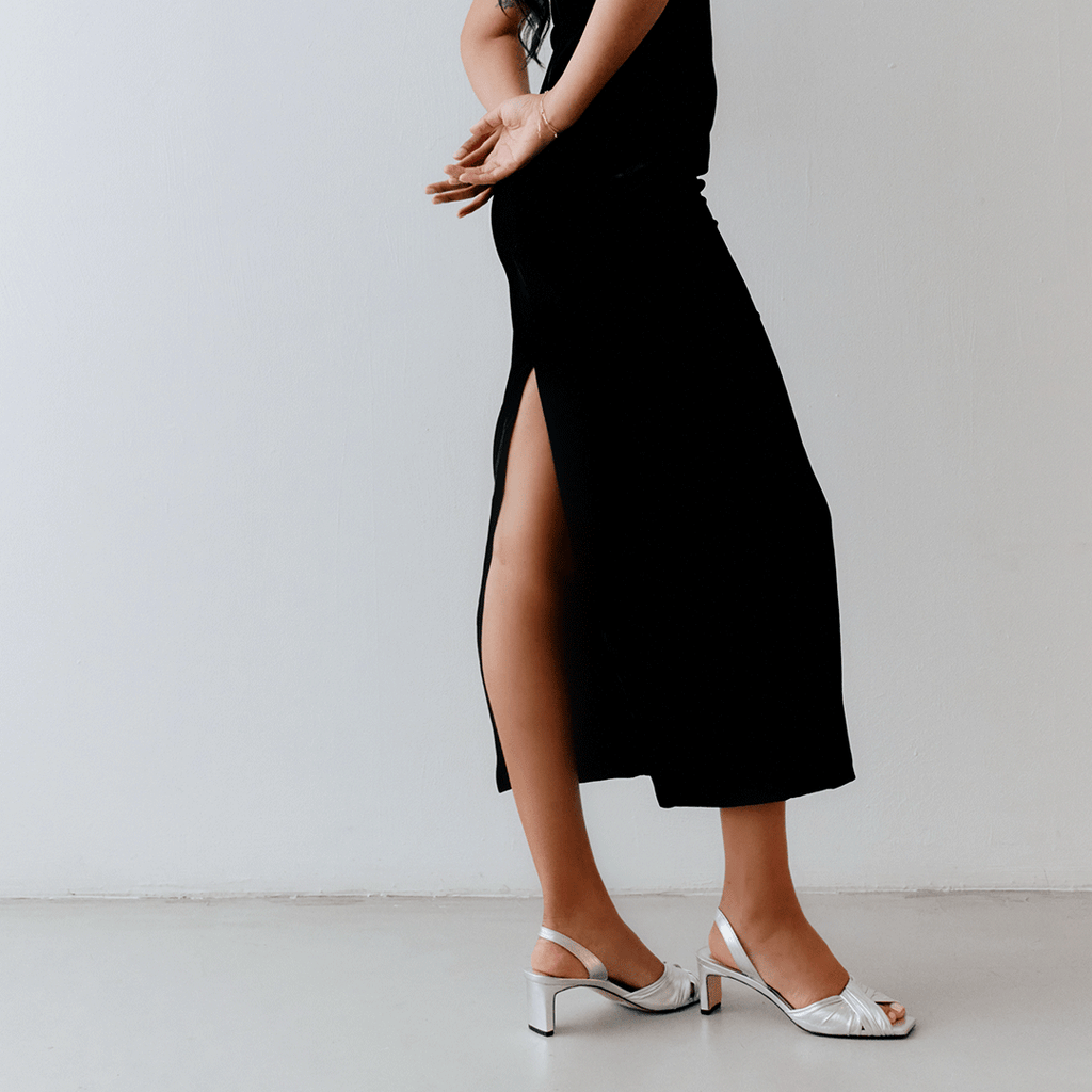 Walking close-up of Riley Leather Low-Heel in silver paired with statement outfit.