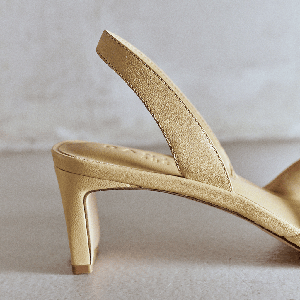Side view of Riley Leather Low-Heel in soft oat highlighting block heel.