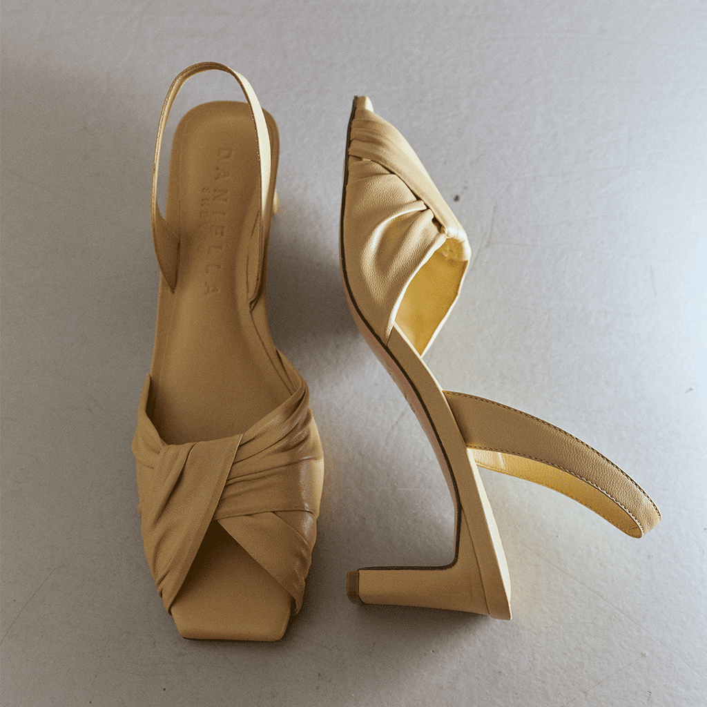 Pair shot of Riley soft oat sandals styled with neutral backdrop.