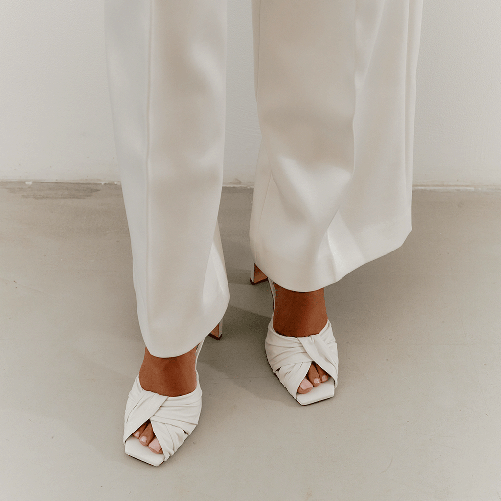 Daniella Shevel Skyler white leather high-heel styled with satin pants.