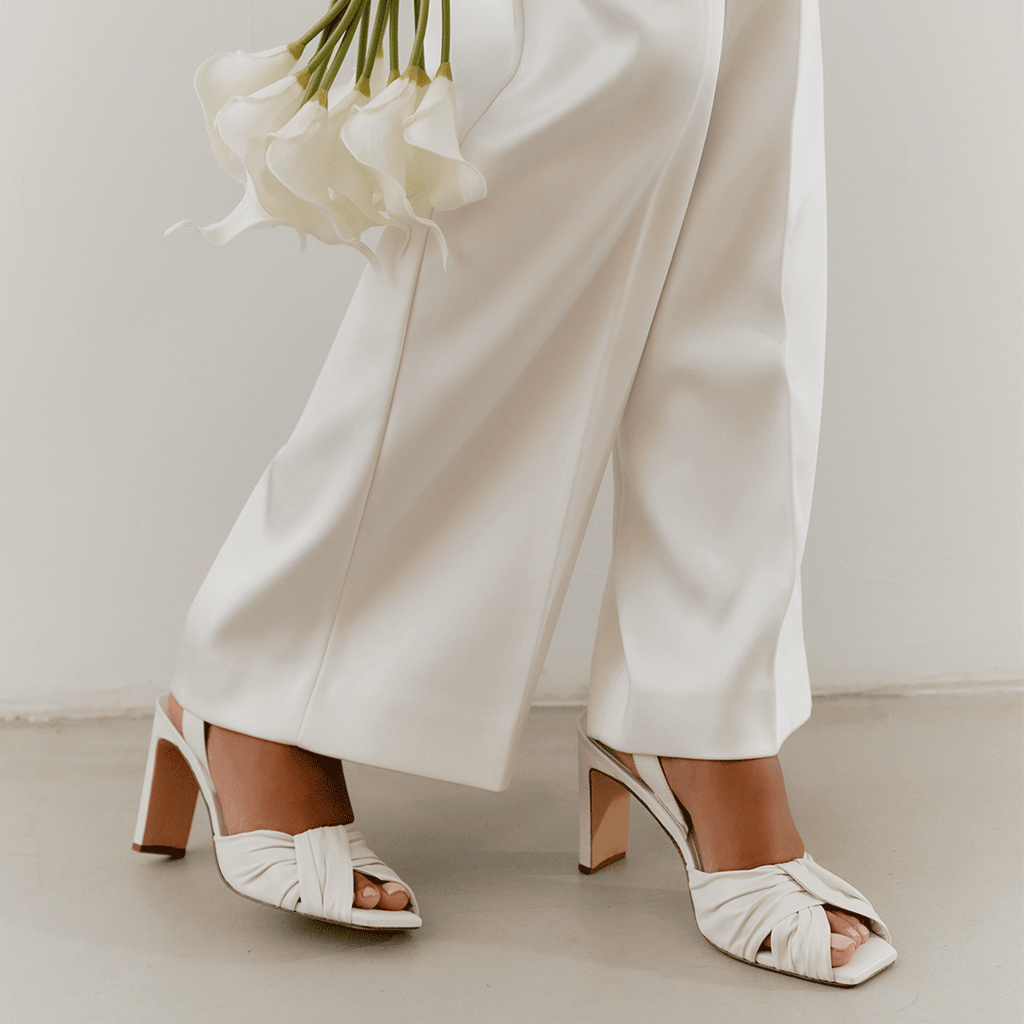 Daniella Shevel Skyler in white styled with flowing linen trousers.