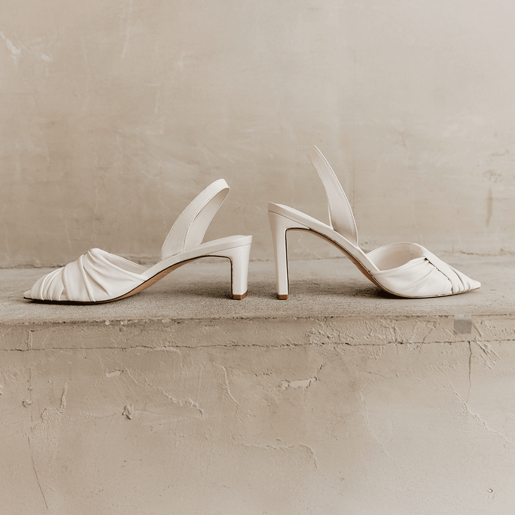Angled side shot of Riley Leather Low-Heel in white highlighting texture.