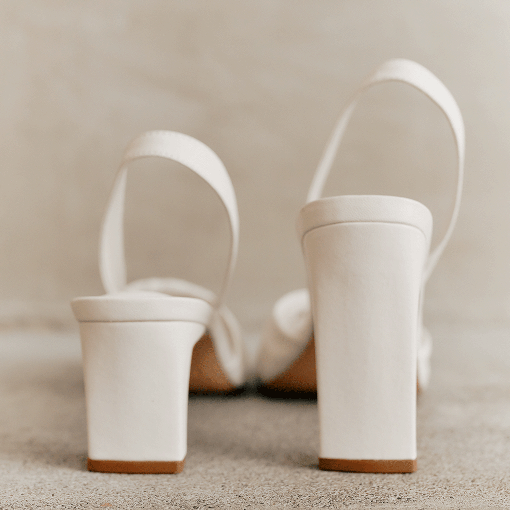 Studio back detail of white Skyler high-heel slingbacks.