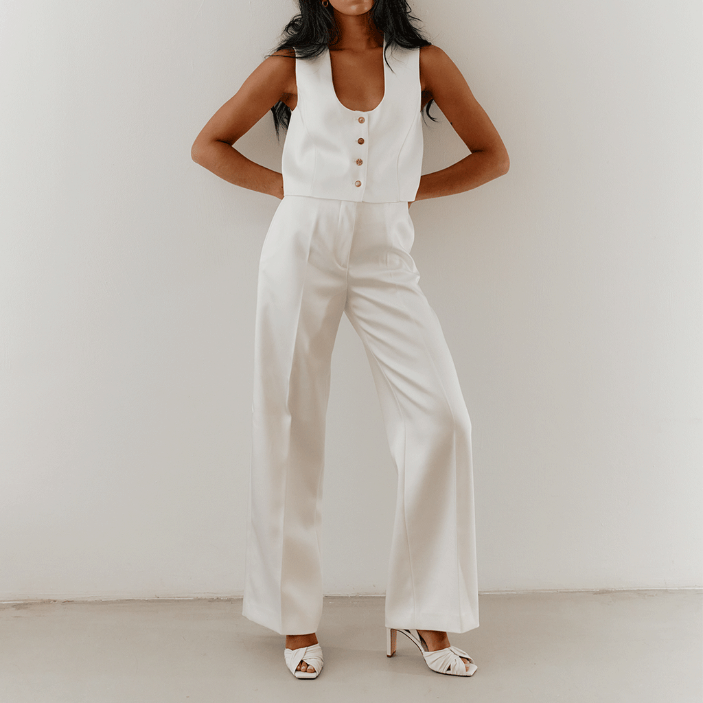 White Skyler leather high-heels styled with sleeveless jumpsuit.