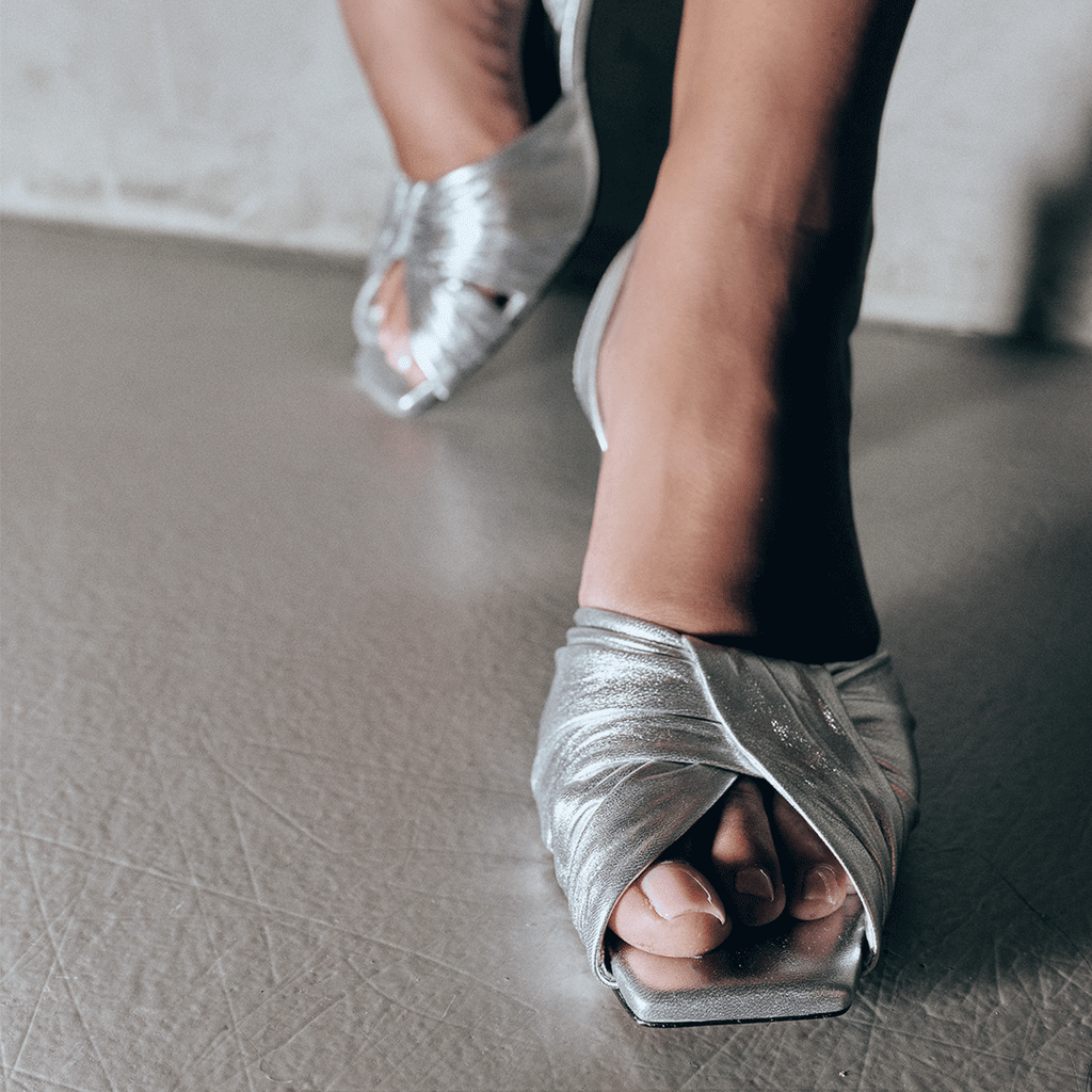 Close-up shot of Riley silver sandals highlighting pleated strap design.