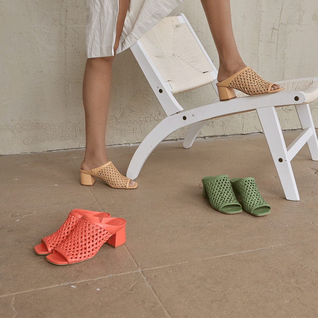 Daniella Shevel Sienna Slide sandals in multiple colorways, including camel, coral, and green, styled together for a vibrant, fashion-forward moment.