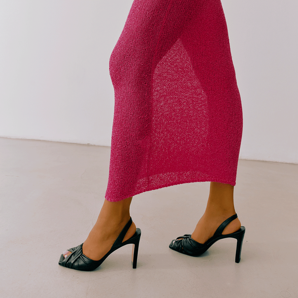 Black Skyler slingbacks styled with pink skirt, lifestyle look.