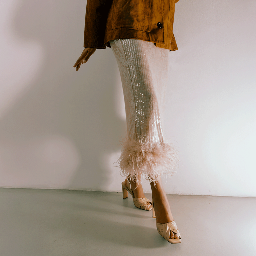 Daniella Shevel Skyler soft oat heel with neutral skirt, front perspective.
