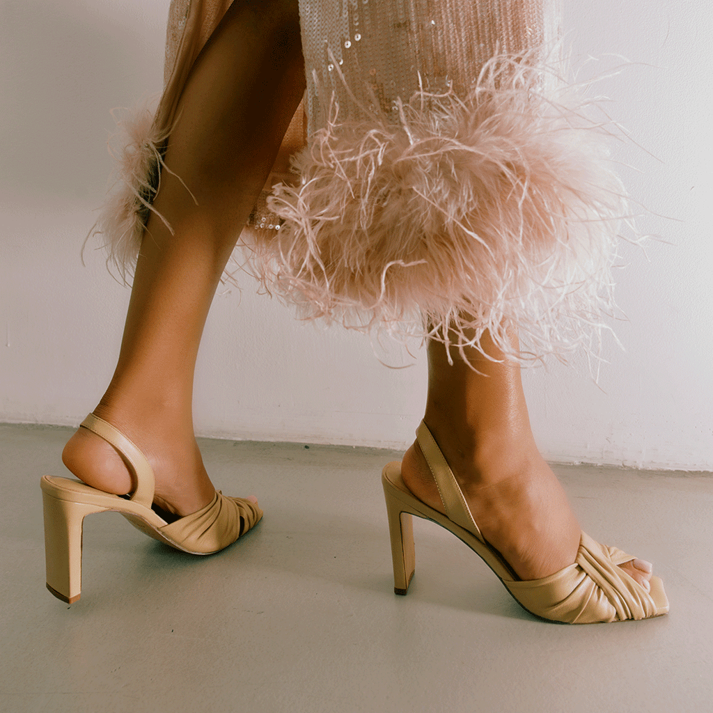 Soft oat Skyler high-heel slingback styled with neutral dress, side angle.