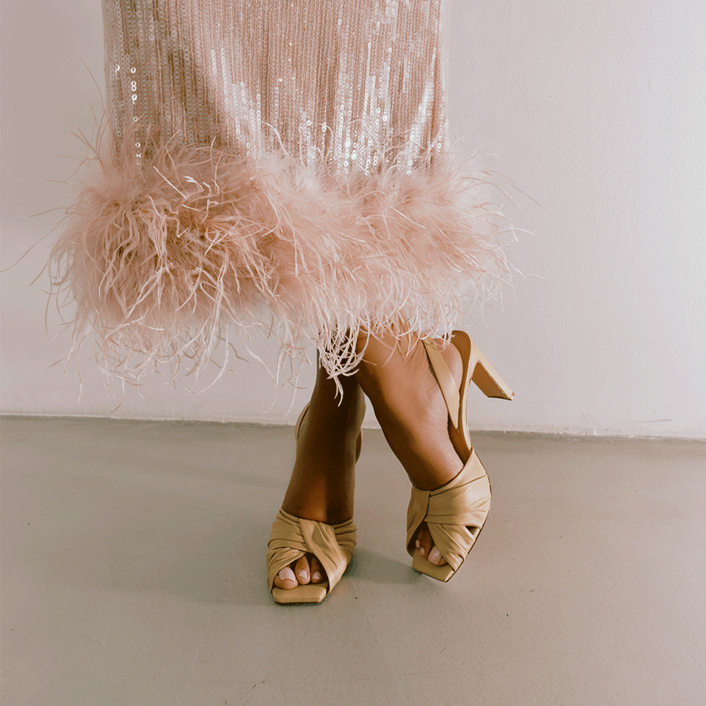 Soft oat Skyler heels paired with midi skirt, studio fashion shot.