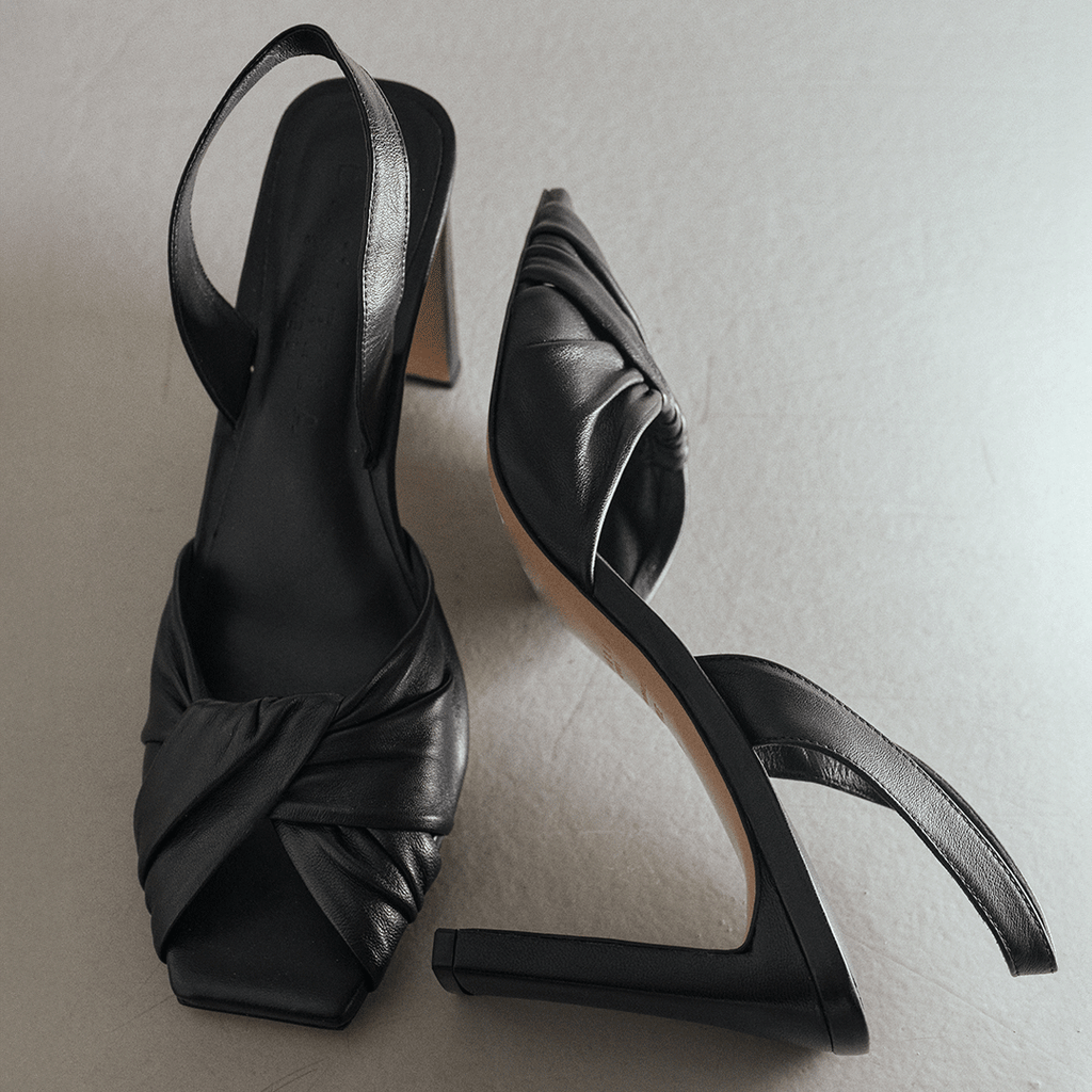 Studio angled shot of Daniella Shevel Skyler black high-heel, leather detail.