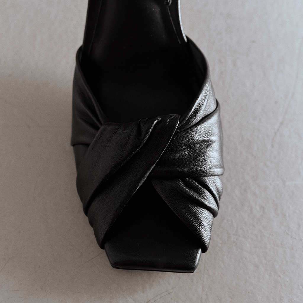 Close-up of Skyler black slingback with pleated leather front.