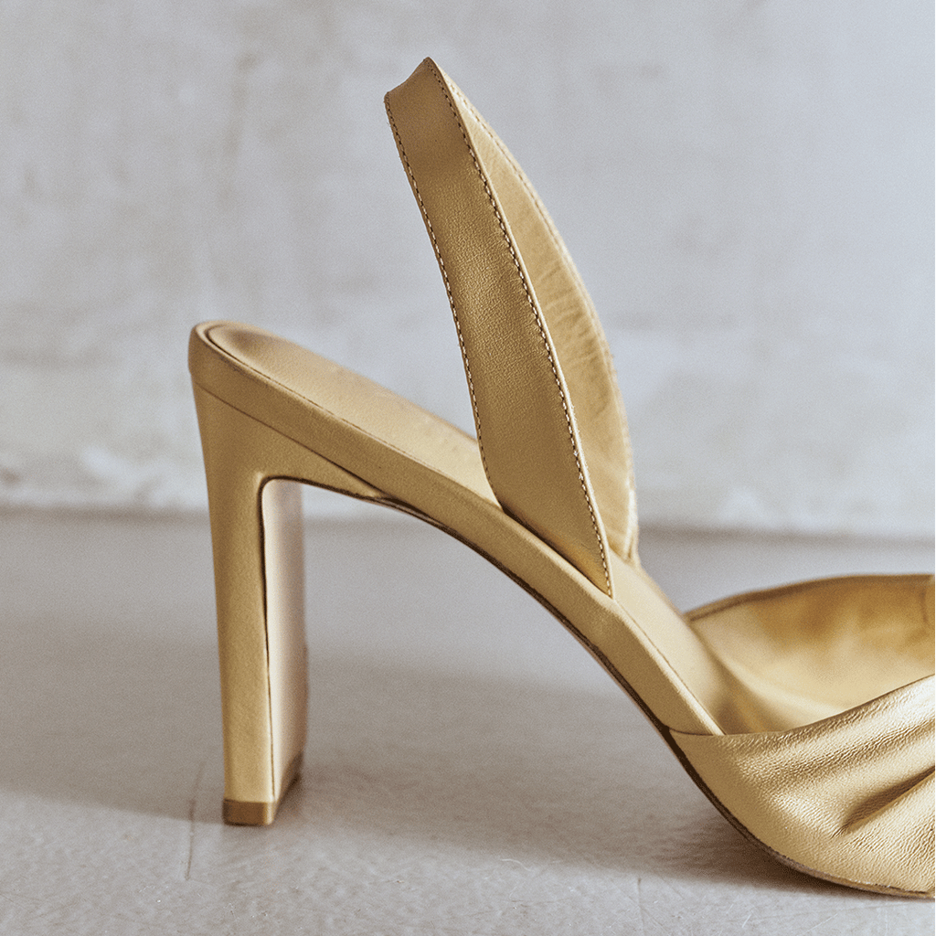 Studio detail of soft oat Skyler leather slingback heel, angled side shot.