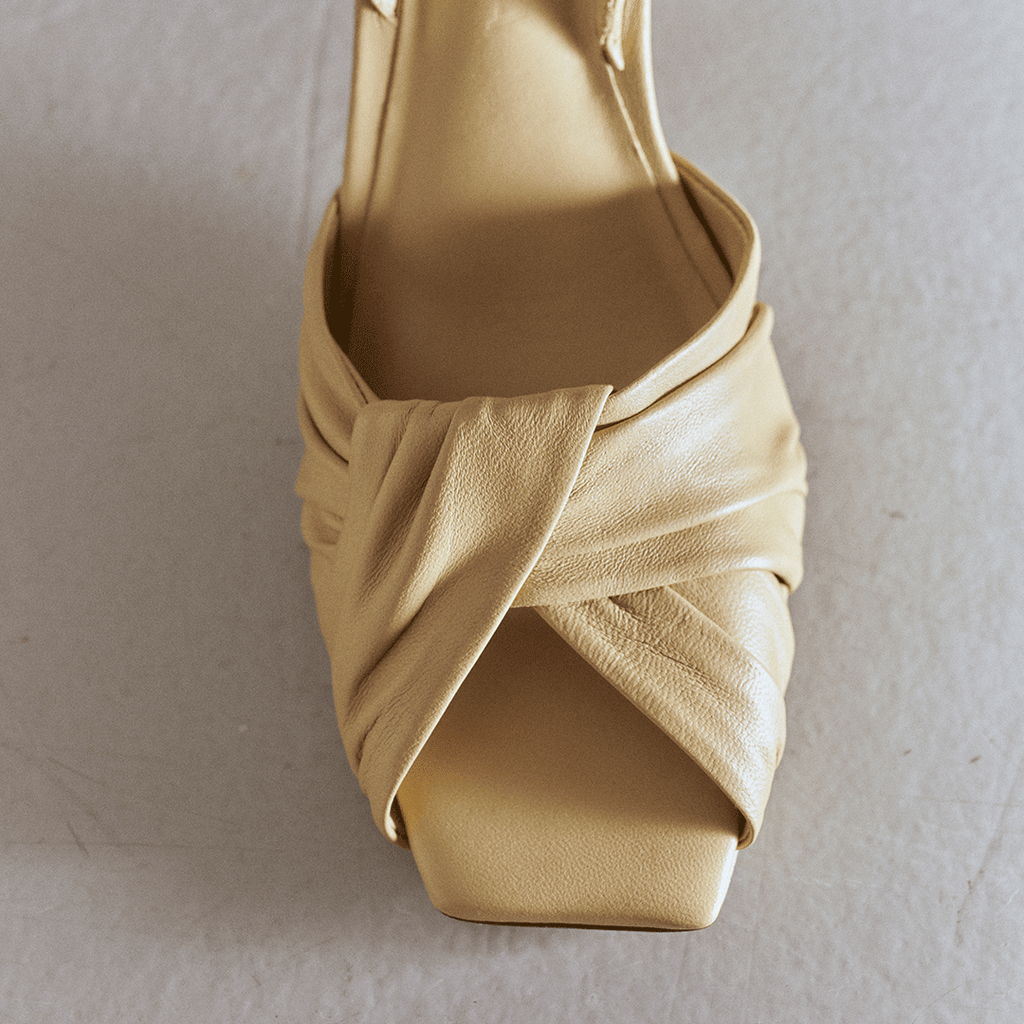 Close-up front view of Skyler high-heel in soft oat leather.