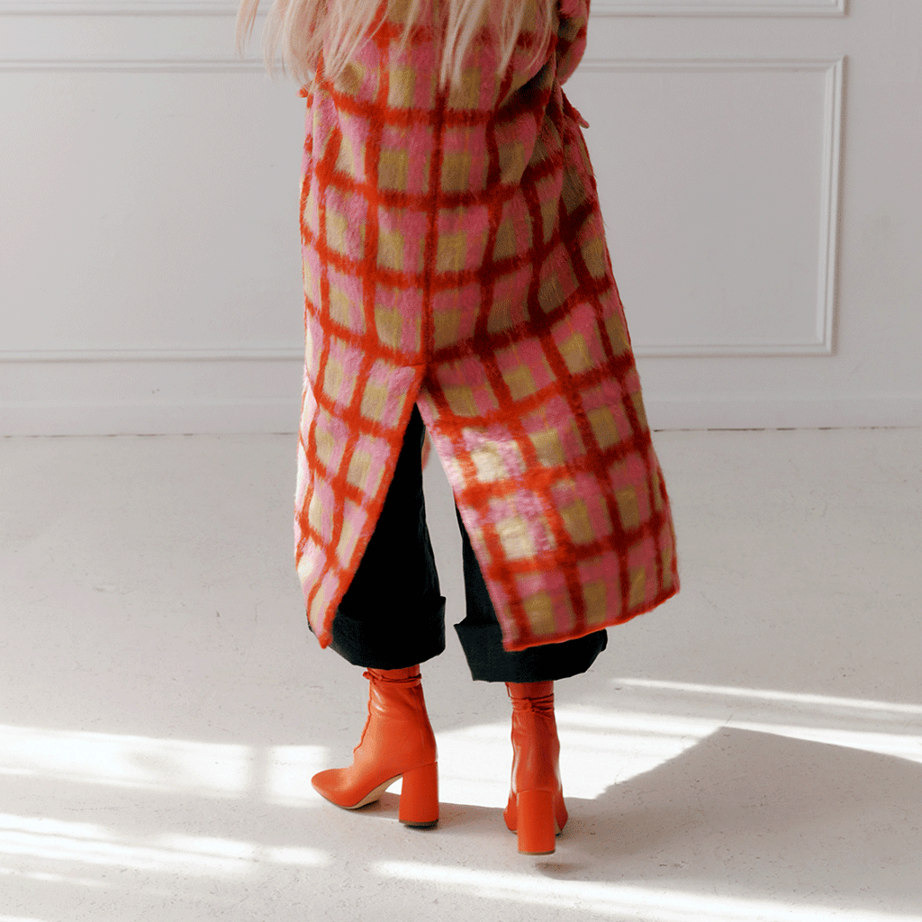 Daniella Shevel Belladonna Lace up boot in lobster red styled in a winter coat