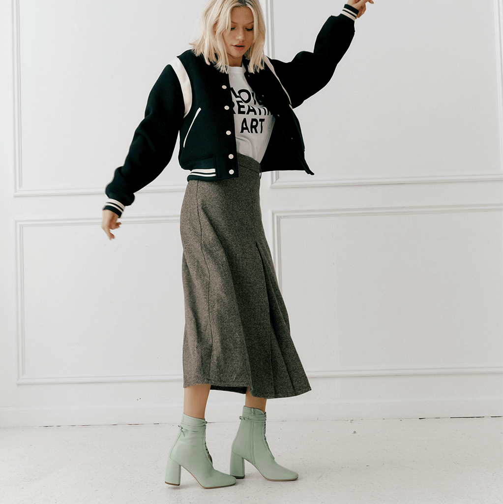 Daniella Shevel Belladonna Mint Green Lace Up Boot styled in a brown skirt and green bomber jacker
