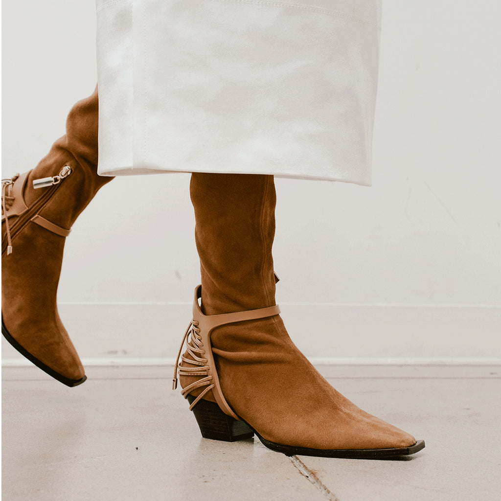 Daniella Shevel Cara knee high boot in moc brown walking in midi dress