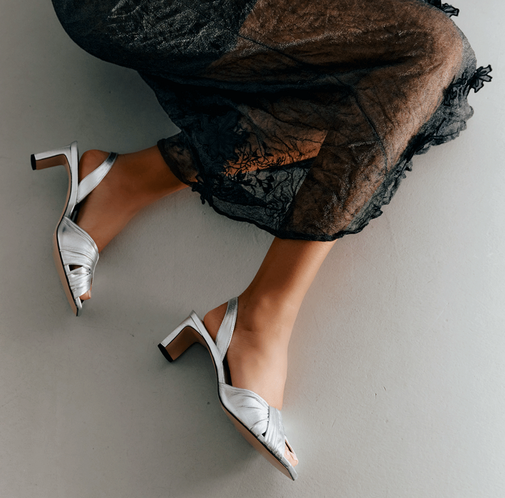 Close-up of Riley Leather Low-Heel in metallic silver, styled with texture detail.