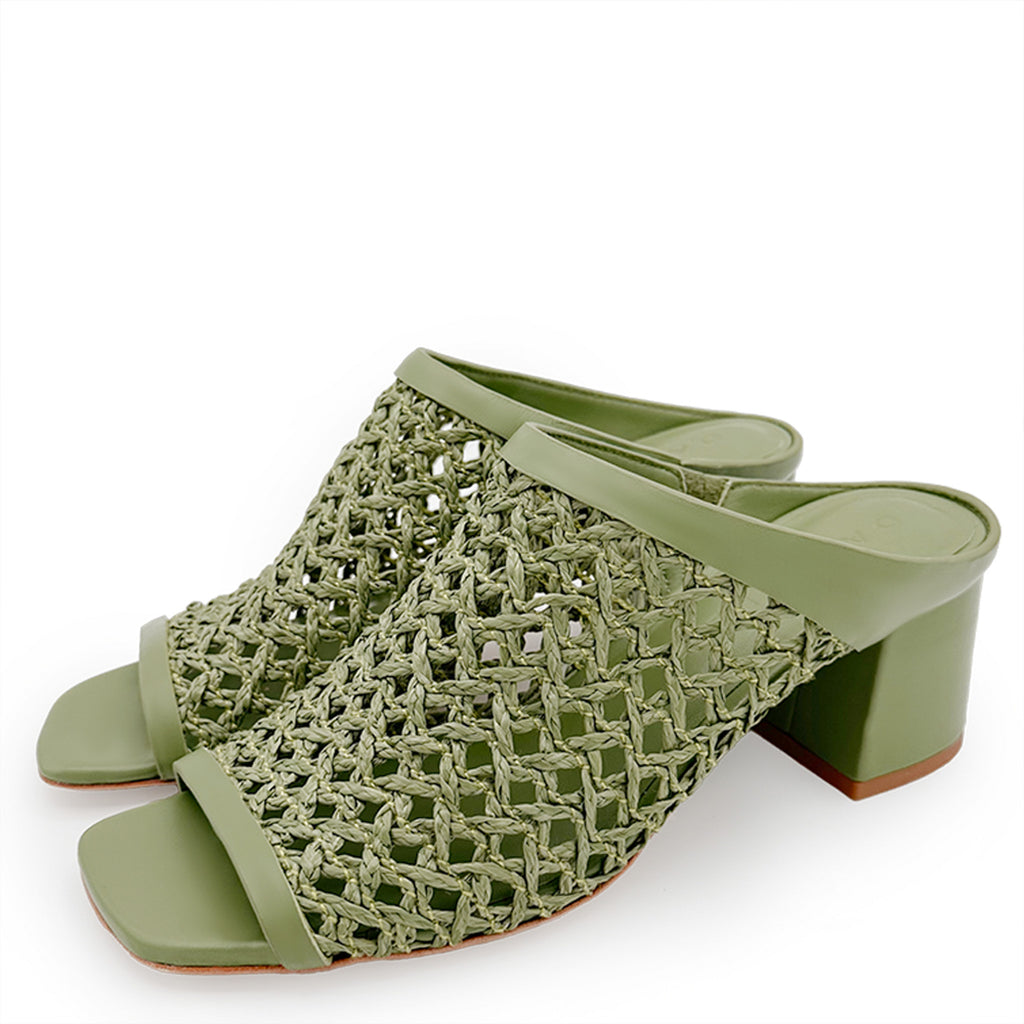 Top-down view of Daniella Shevel Sienna green woven mules, displaying the intricate cut-out design and craftsmanship.
