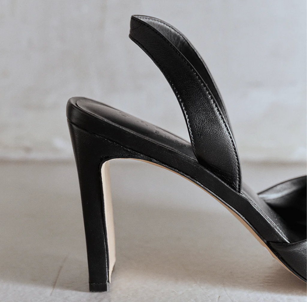 Studio side angled detail of Skyler black high-heel slingback.