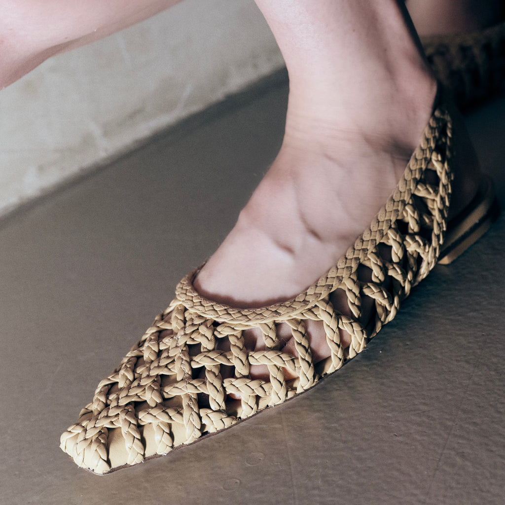 Side angle close-up of foot in Daniella Shevel Halo Soft Oat flats – zoomed in on handwoven craftsmanship and natural tone.