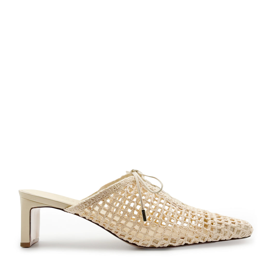 Daniella Shevel Lina raffia mule in Wild Straw shown on white background, featuring sculpted heel, handwoven mesh upper, and neutral almond-toe silhouette—perfect for warm-weather elegance.